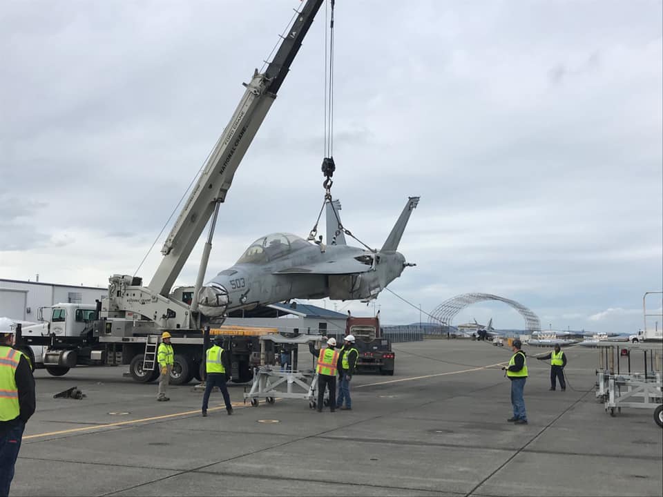 Photos show EA-18G Growler damaged in 2017 mid-air collision arriving at NAS Whidbey Island via truck to be repaired