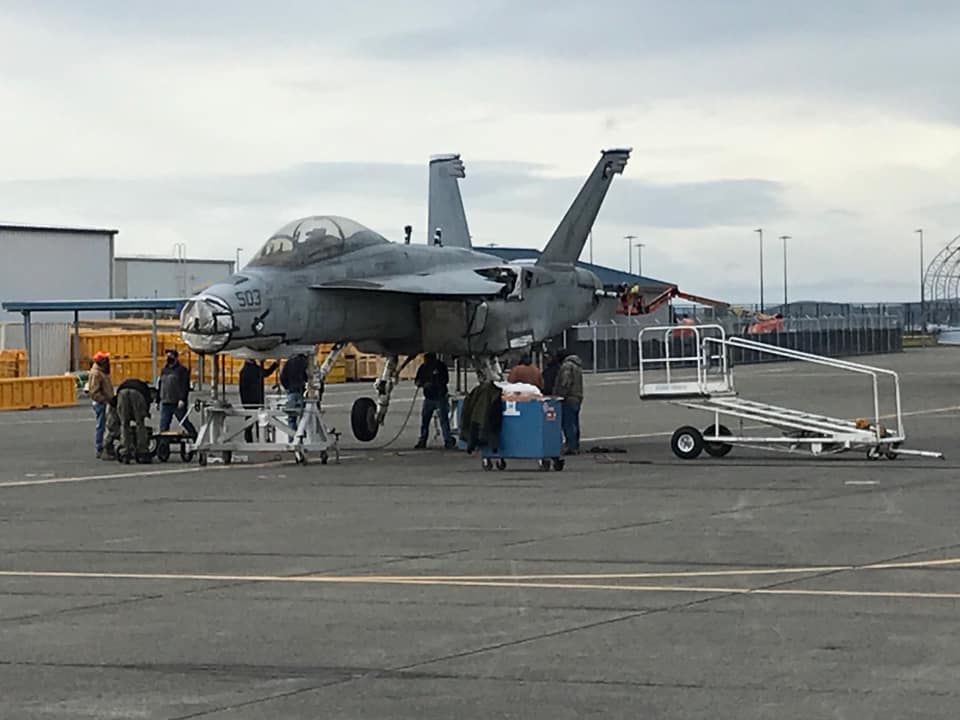 Photos show EA-18G Growler damaged in 2017 mid-air collision arriving at NAS Whidbey Island via truck to be repaired