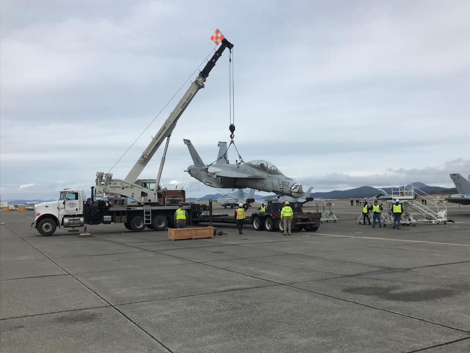 Photos show EA-18G Growler damaged in 2017 mid-air collision arriving at NAS Whidbey Island via truck to be repaired